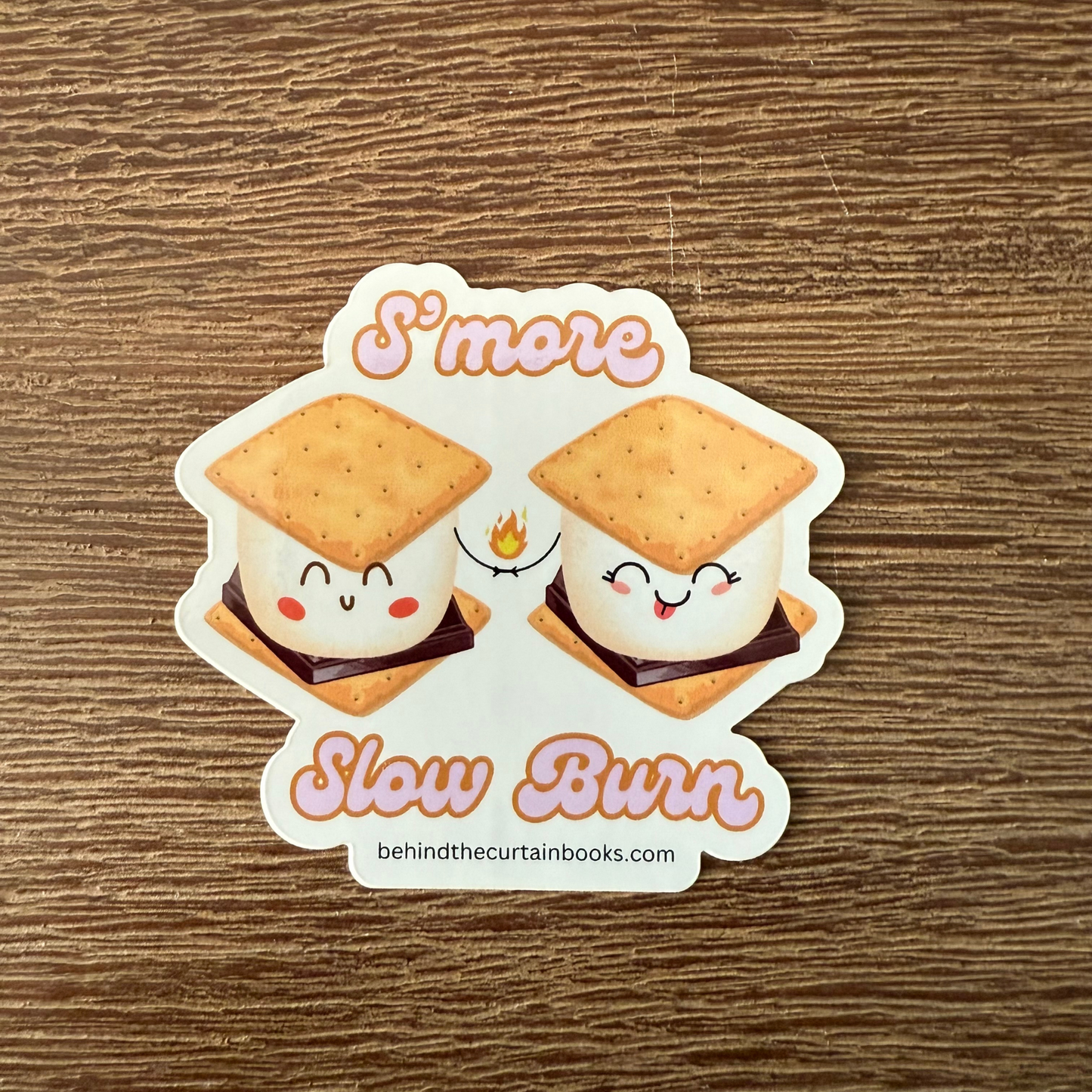 Sticker of two cartoon s'mores with a wooden background