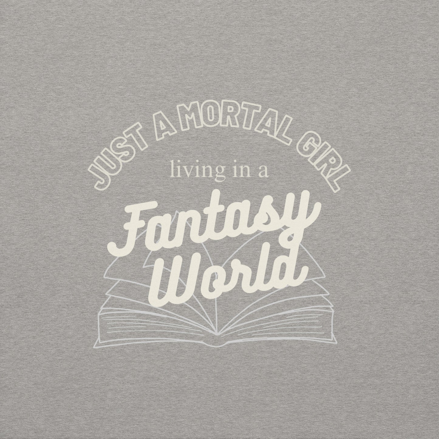 Gray t-shirt with white text 'Just a mortal girl living in a fantasy world' and an open book graphic.