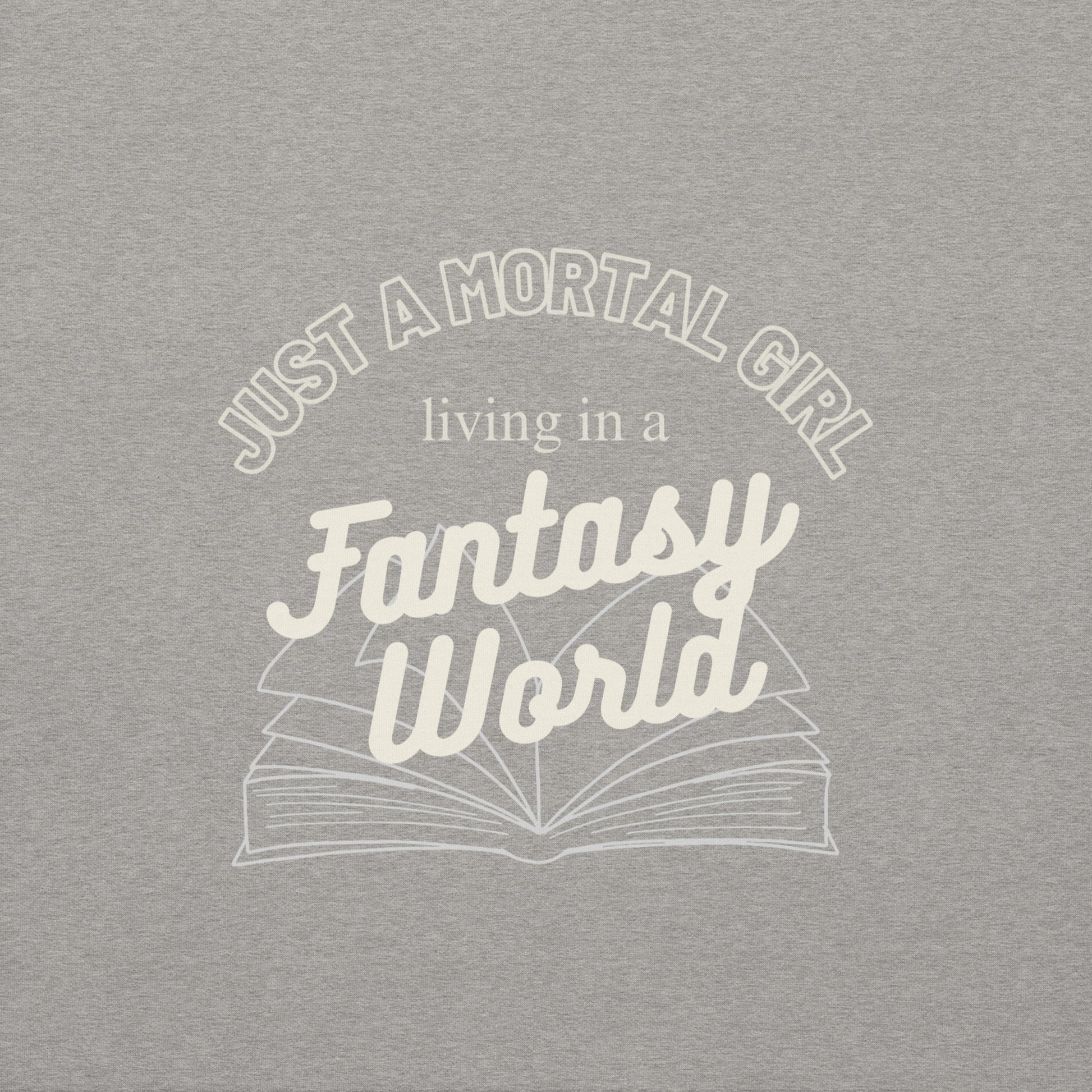 Gray t-shirt with white text 'Just a mortal girl living in a fantasy world' and an open book graphic.